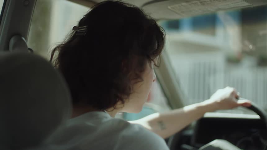 A woman gets out of the car