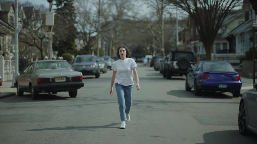 A woman gets out of the car and runs down the road