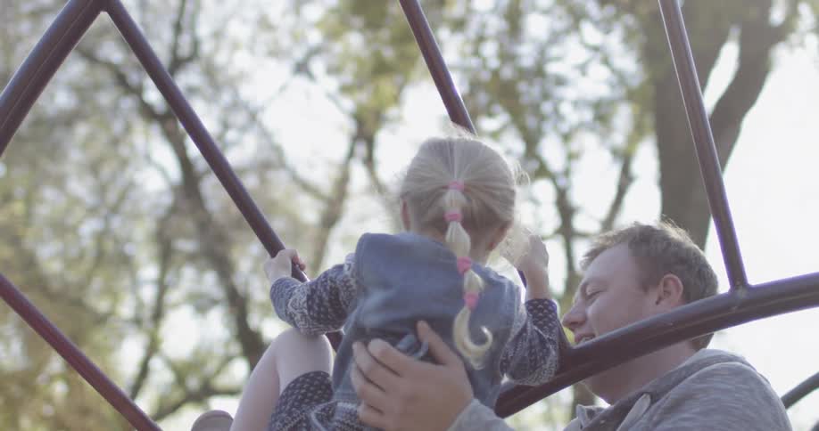 Parents play with their kids in a park