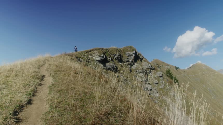 A man is dirt biking down a rocky hill