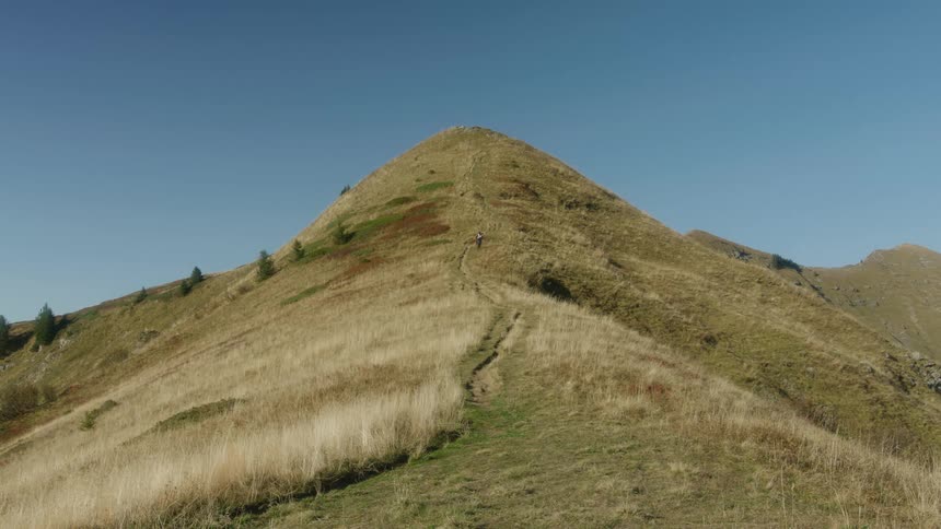 A person is dirt biking down a hill in spring