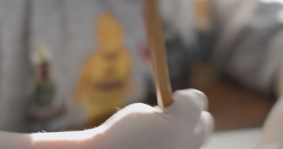 A child is using a pencil to color with