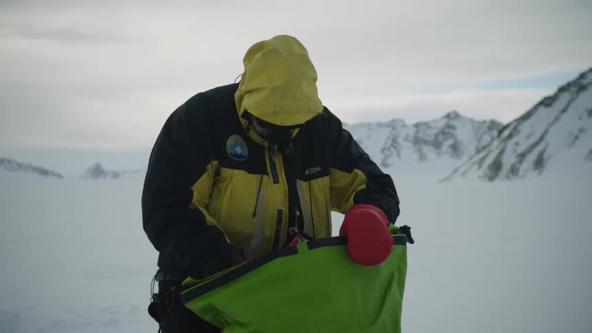 A man is searching through his bag