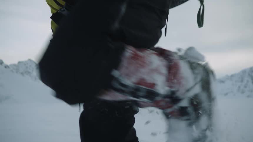 A man is hiking through the snow in winter