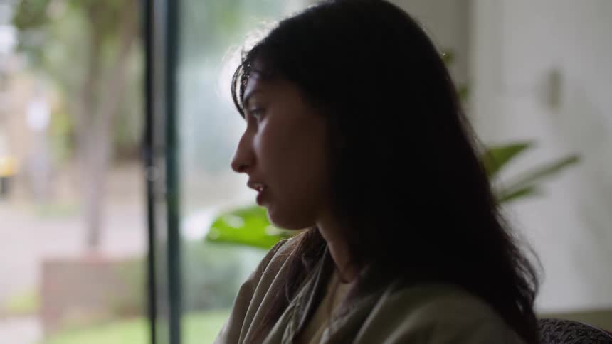 A man and woman play musical instruments over a video call