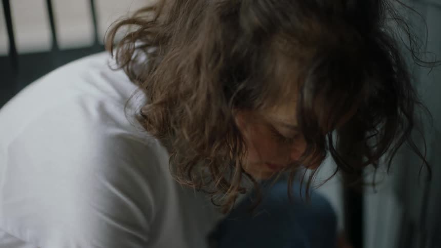 Worried woman in a rush knocks on door and tries knob before using key