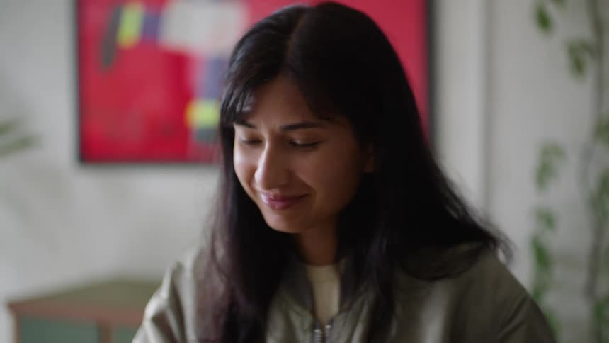 A woman playing a piano keyboard rocking back and forth and smiling