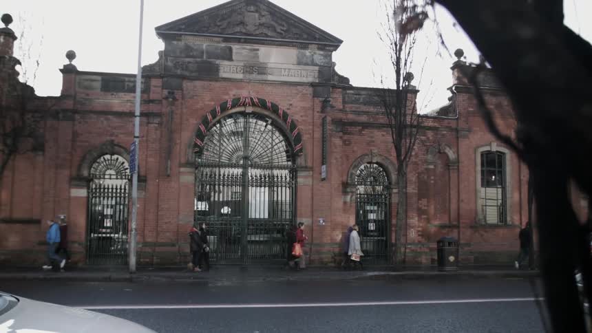 People walk in front of a closed gateway