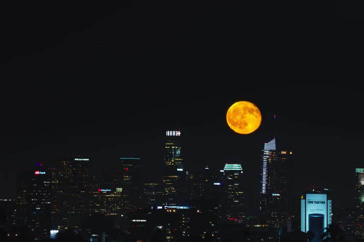 Time lapse photography of a the moon rising over Los Angeles at night