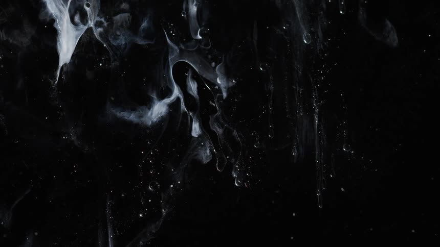 White wisps move slowly on a black background