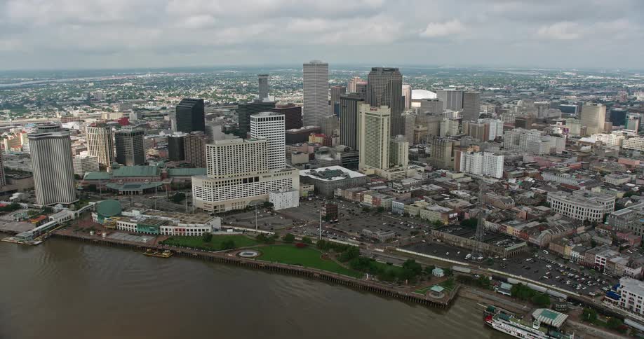 Aerial footage shows fly-over of Mississippi River Downtown New Orleans and skyscrapers approaching the Superdome in Louisiana