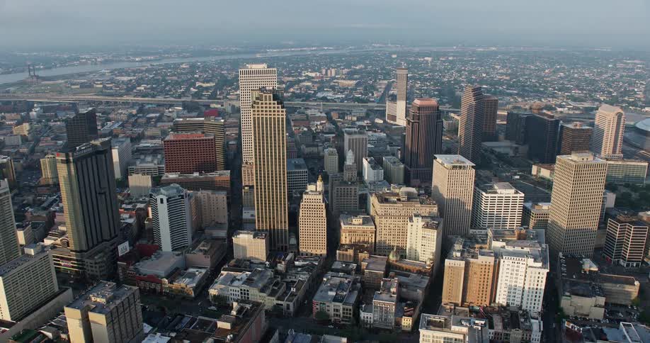 Aerial footage of tall skyscrapers in Downtown New Orleans at sunrise during summer
