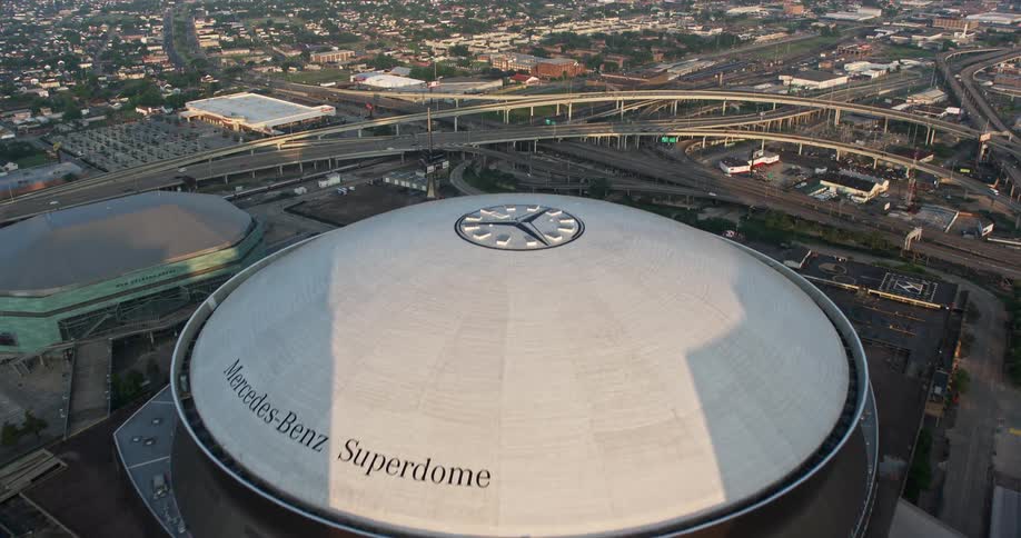 Approaching the Superdome at sunrise this 4K aerial footage showcases the high-rise buildings and downtown area of New Orleans Louisiana