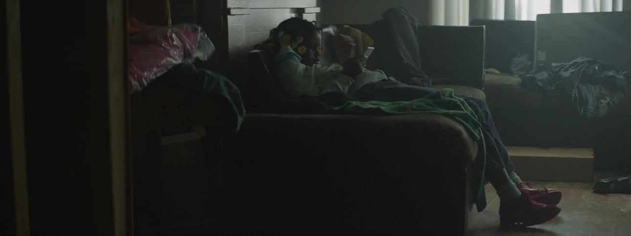 A young girl plays a game on a couch