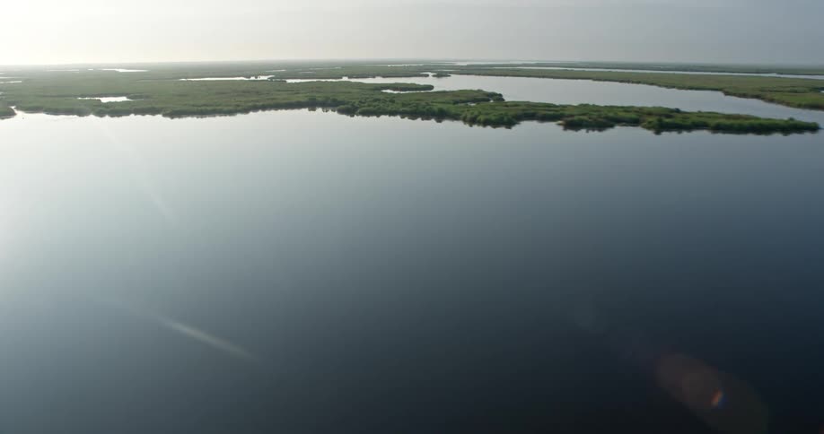 An aerial shot reveals the beautiful marshland and bayou during a stunning sunrise in St Bernard Parish Louisiana