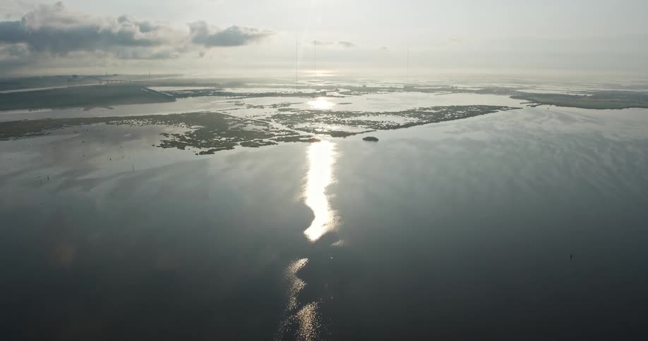 Aerial 4K footage approaching marshland during sunrise over a lake in St Bernard Parish Louisiana
