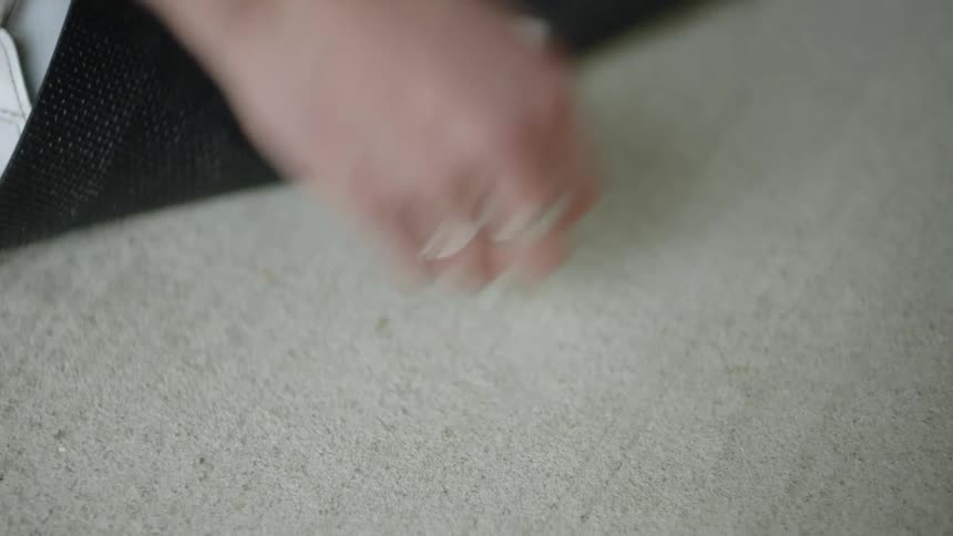 Woman flips doormat up to access house key