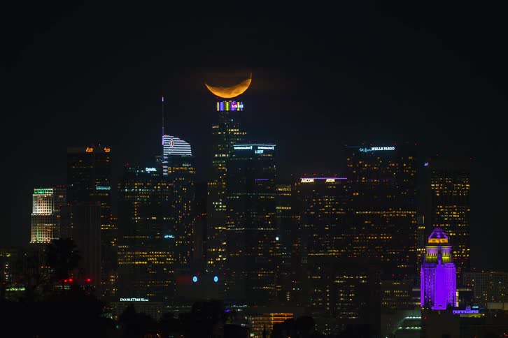 Time lapse view of the moon above the city