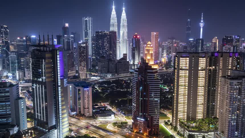 Illuminated skyscrapers high rise buildings and towers in the Kuala Lumpur city center at night