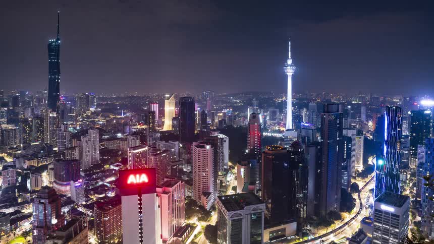 Timelapse of illuminated skyscrapers and high rise buildings in KLCC at night