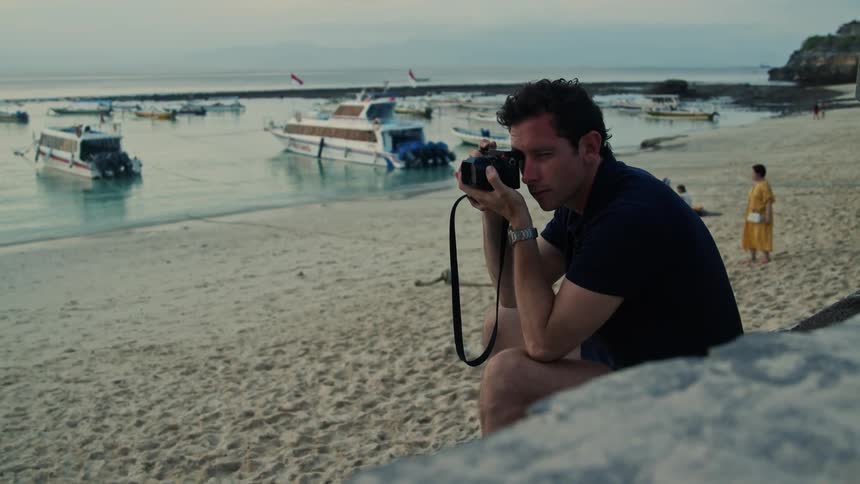 A man is taking photos on the beach