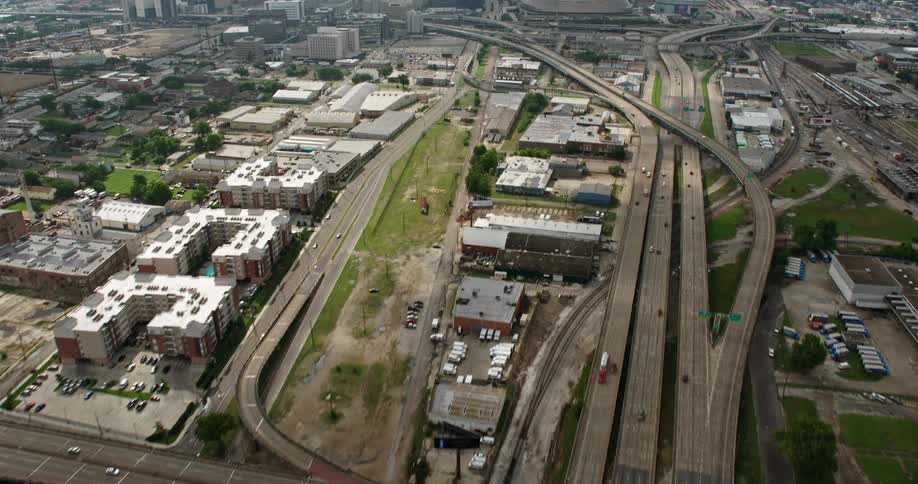 An aerial shot of Interstate 10 approaching Downtown New Orleans Louisiana on a cloudy day showing the city skyline