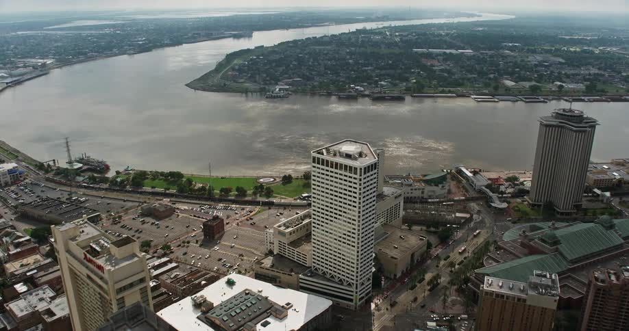 A breathtaking aerial view of the Superdome and Downtown New Orleans with skyscrapers and high rise buildings near the Mississippi River on a beautiful summer day