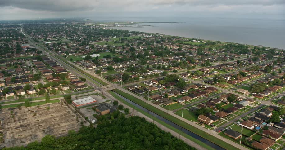 Approaching suburban neighborhoods by a lake at sunrise in New Orleans East during spring time