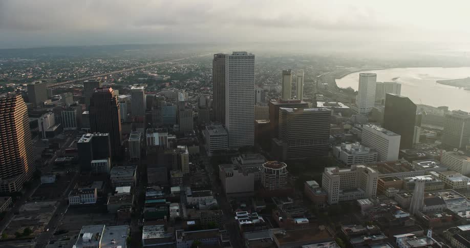 Fly over Downtown New Orleans and the French Quarter from an aerial view at sunrise on a summer morning