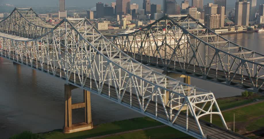 A stunning 4K aerial flyby of the Crescent City Connection Bridge revealing the Downtown New Orleans skyline at sunrise