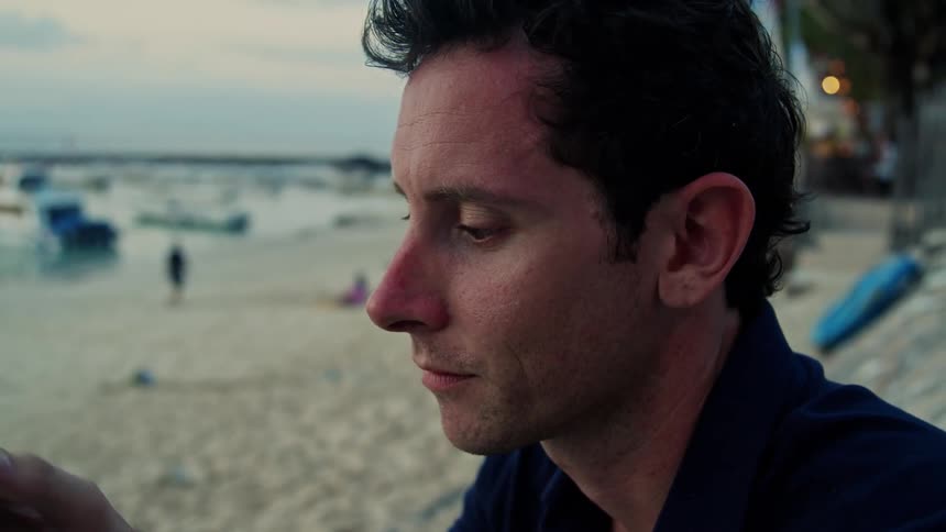 Close up of man taking picture with camera at the beach