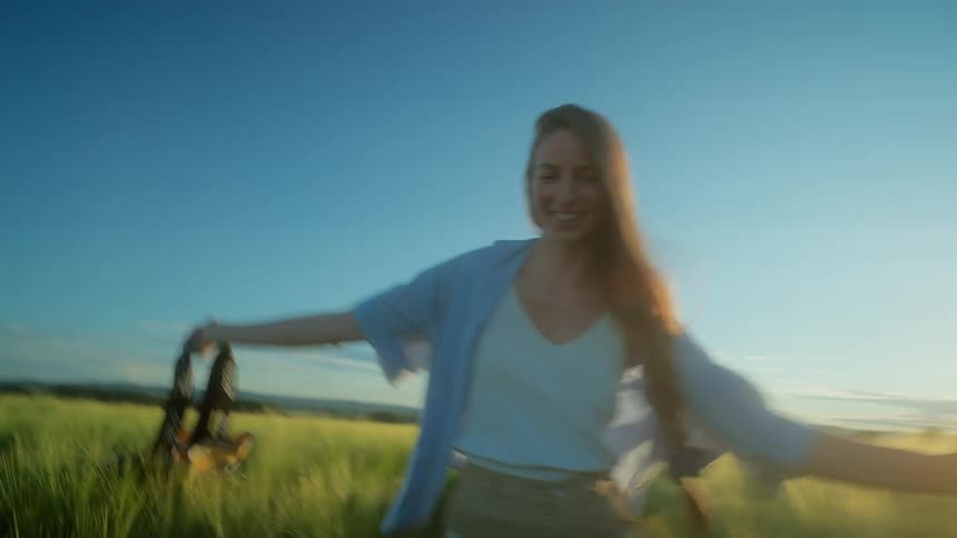 A woman is running through a grassland field