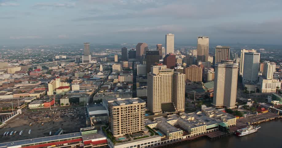 A stunning 4K aerial view of Downtown New Orleans during sunrise while overlooking the Mississippi river