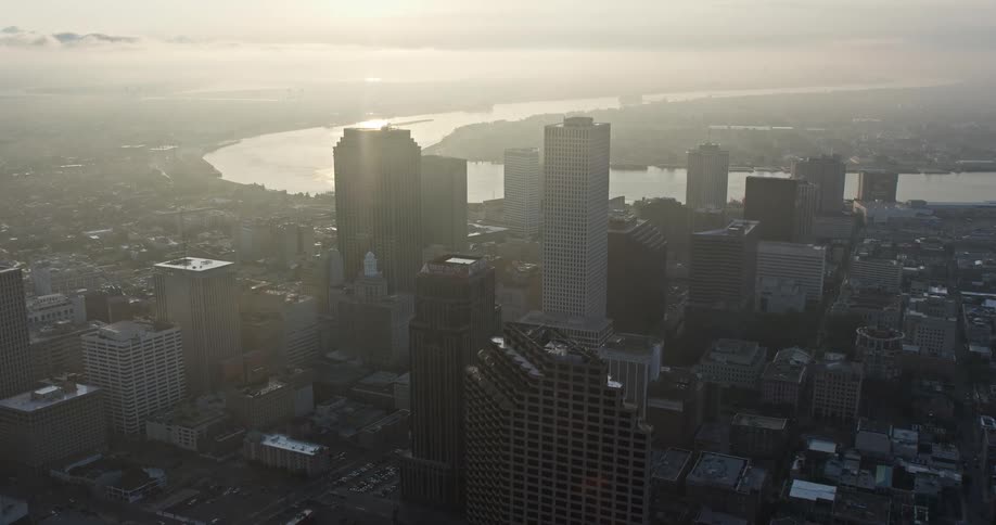A stunning 4K aerial flyover of Downtown New Orleans at sunrise towards the Mississippi River capturing the citys high-rise buildings and skyscrapers