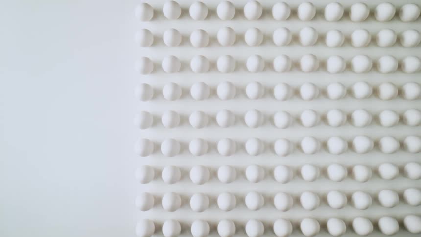 Rows of eggs are displayed on a table