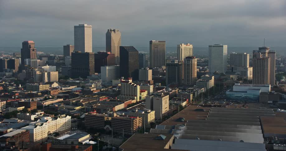 Stunning 4K aerial footage of Crescent City Connection Bridge and Downtown New Orleans skyline at sunrise during summer