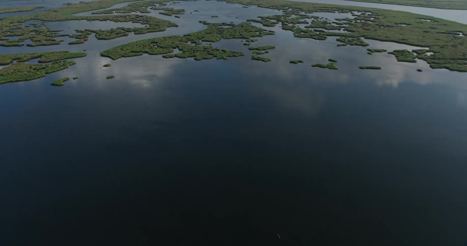 Aerial footage at sunrise captures the beautiful bayou marshlands of St Bernard Parish with a reveal of the IHNC Lake Borne surge barrier in Louisiana