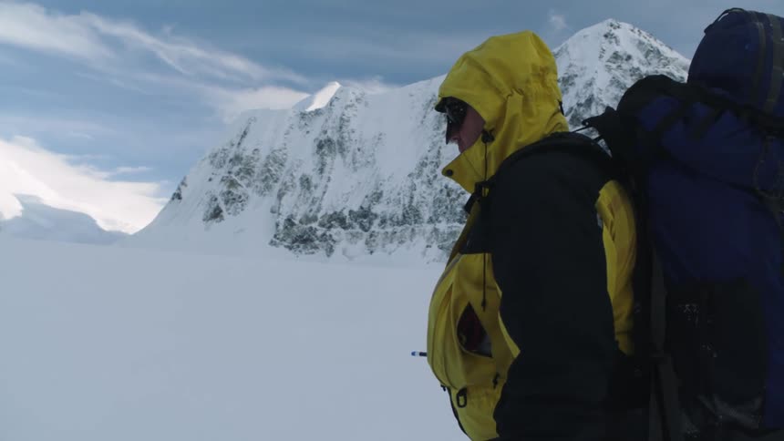 A man is hiking through the arctic region
