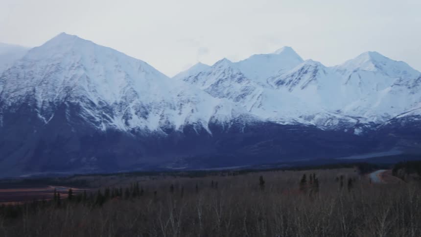 Snow covered mountain in the horizon is displayed