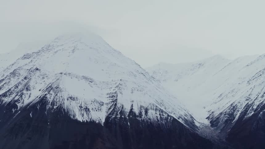 Aerial view of mountains during winter is displayed