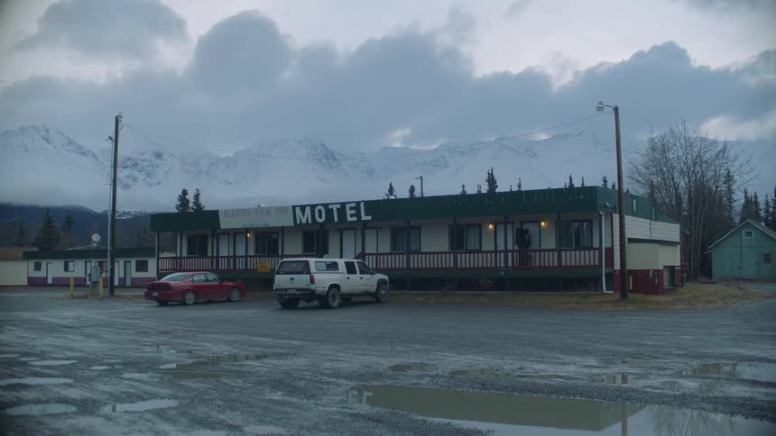 Landscape of motel and distant snowy mountain range