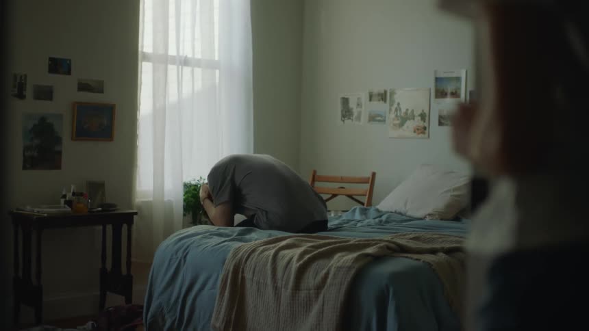 Young woman follows a man into the bedroom after a fight