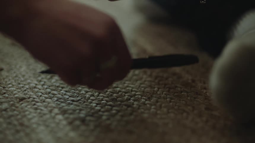 Close up of womans hand picking up pen