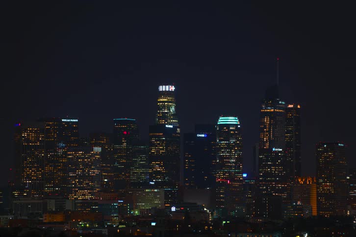 A time lapse of a metropolis skyline from dawn to night with rising moon