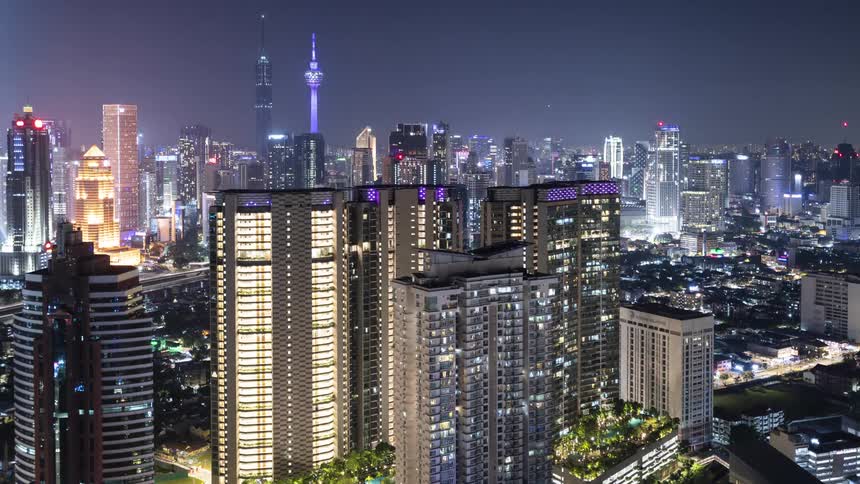 Brightly illuminated skyscrapers and towers in the Kuala Lumpur city center at night