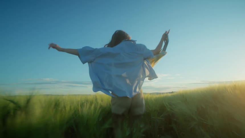 A woman is running through a grassland field
