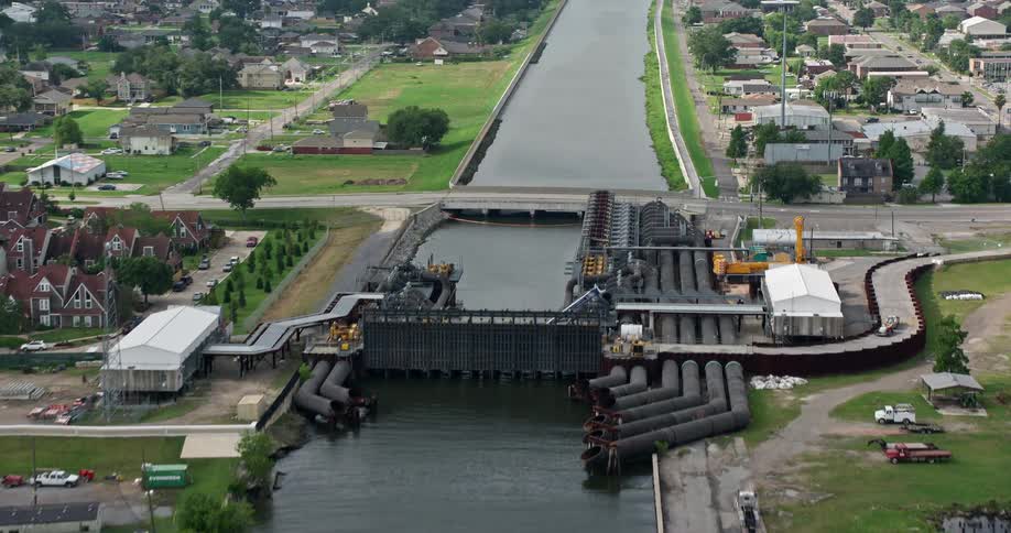 Approaching and flying over 17th Street Canal pumping station in Metairie Louisiana during a cloudy day