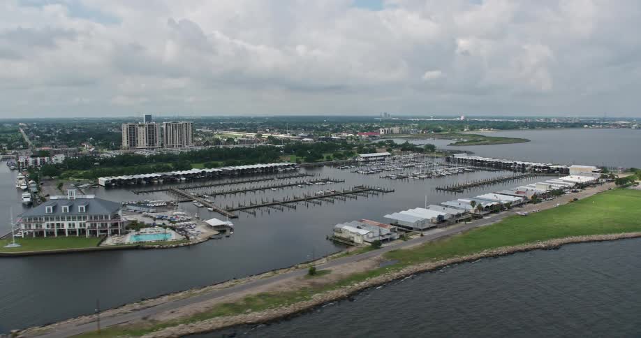 This is an aerial view of a marina and Breakwater Park with Lake Pontchartrain Shore in Lakeview New Orleans during summer