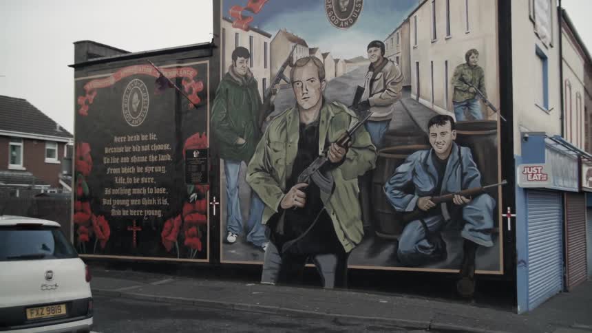Two large murals on the side of buildings in a city
