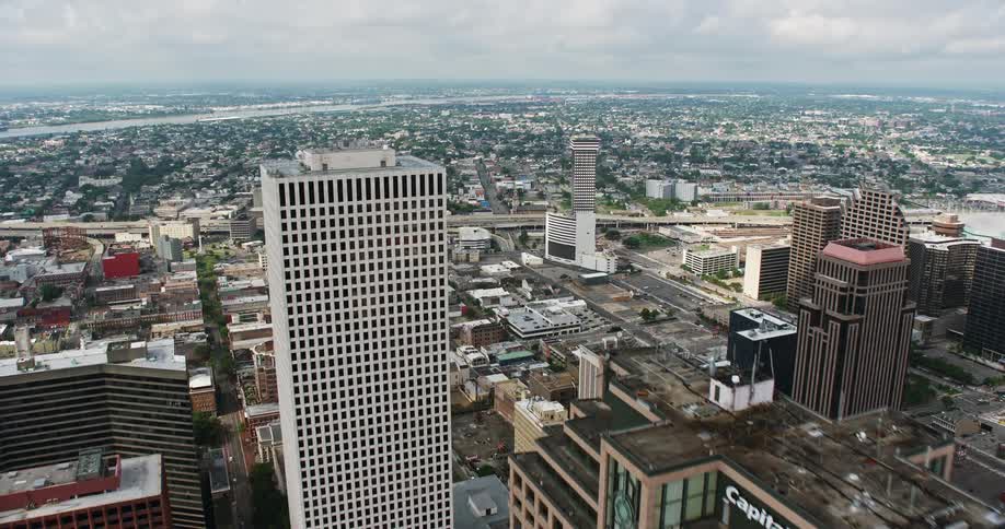 A breathtaking 4K aerial footage of Downtown New Orleans during daytime featuring the stunning Place St Charles and One Shell Square buildings as the camera tilts up for an aerial view of the metropolis